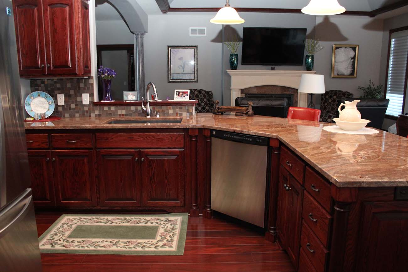 A kitchen with wooden cabinets and granite counter tops