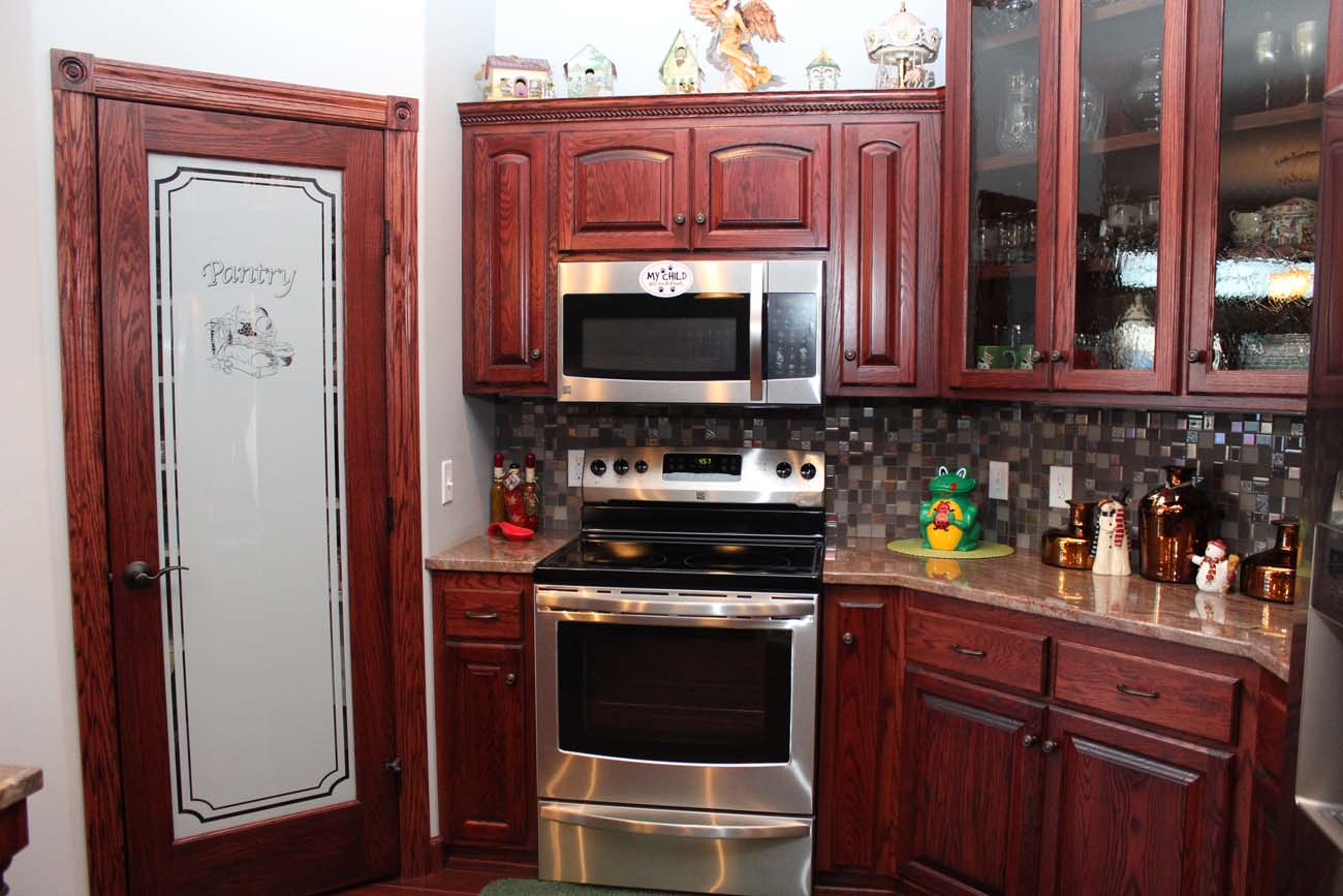 A kitchen with stainless steel appliances and wooden cabinets