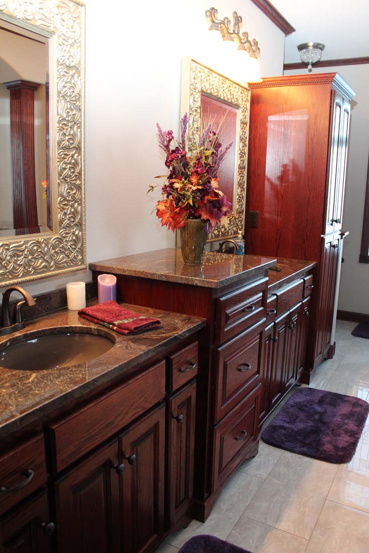 A bathroom with a sink and a vase of flowers on the counter