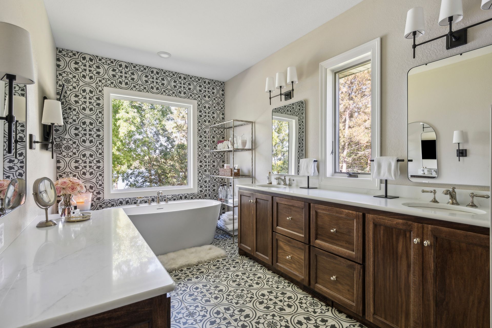 Modern bathroom with double vanity, freestanding tub, and patterned tile floor in neutral tones