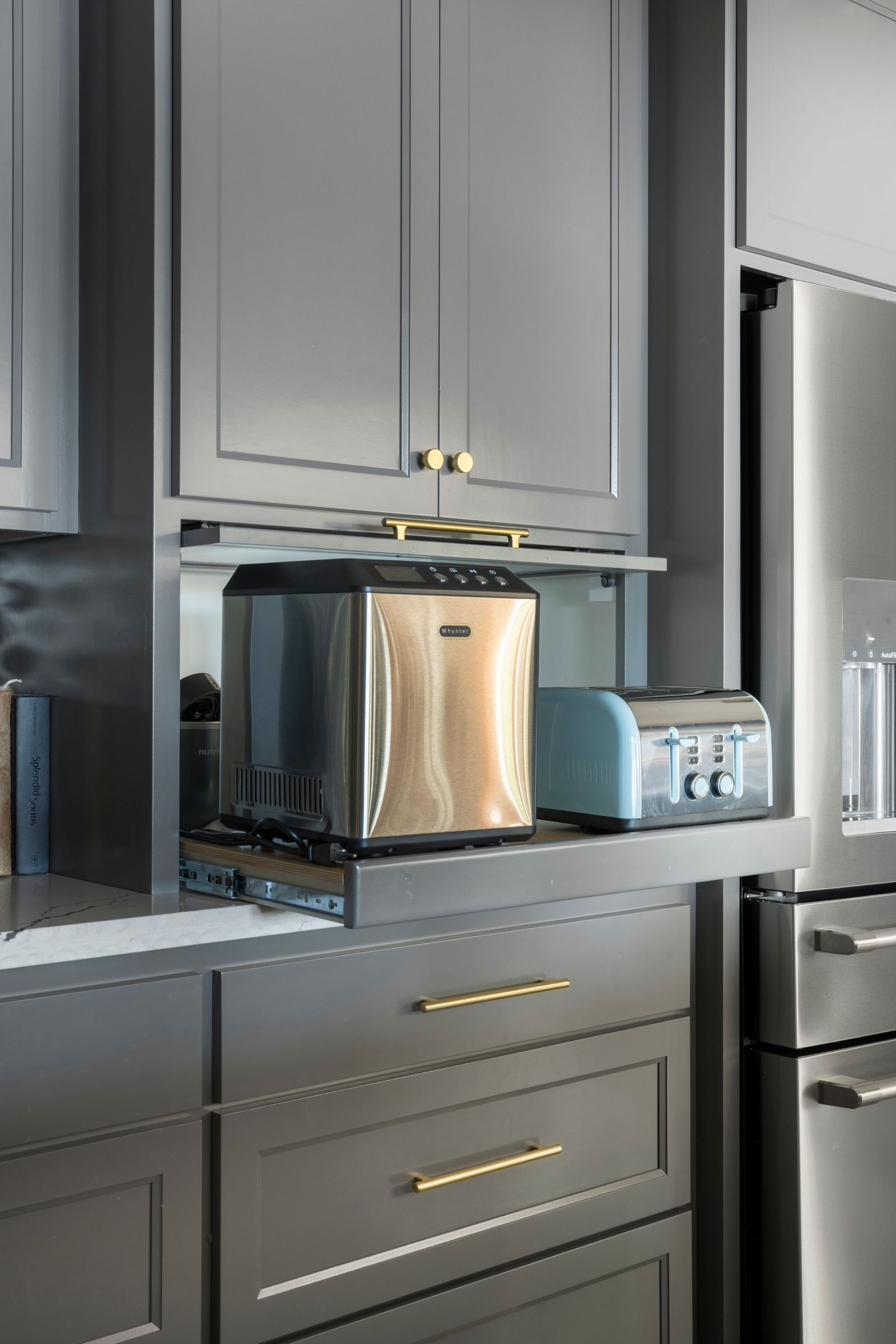 Built-in coffee station with espresso machine, toaster, and blender in a modern gray kitchen