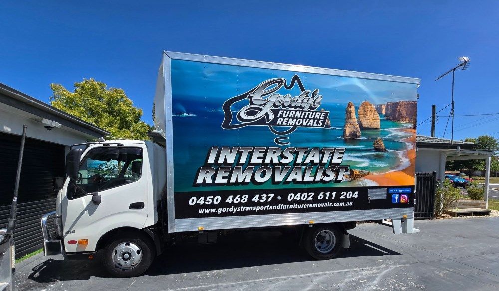 A White Interstate Removals Truck is Parked in a Parking Lot — Gordy's Furniture Removals in Bathurst, NSW