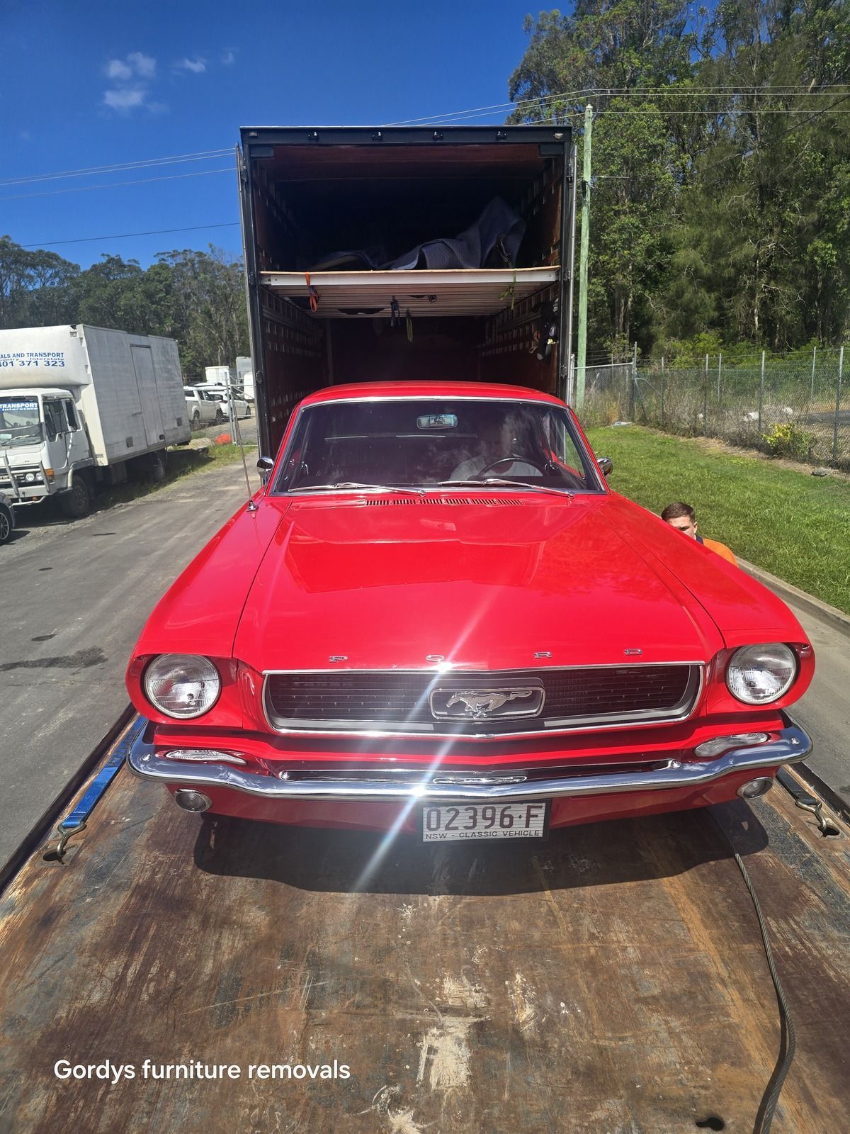 A Black Truck Inside A Trailer Truck — Gordy's Furniture Removals in Bathurst, NSW