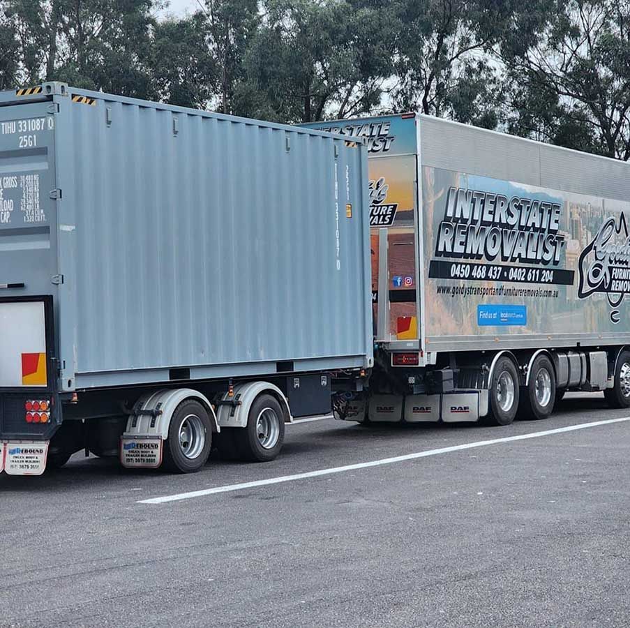 A Large Interstate Removals Truck is Parked on the Side of the Road — Gordy's Furniture Removals in Bathurst, NSW