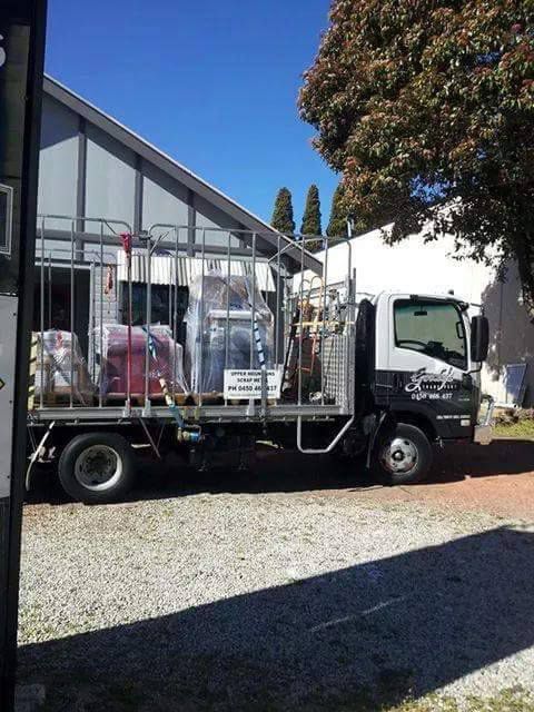 A White Truck Is Parked In Front Of A Building — Gordy's Furniture Removals in Bathurst, NSW