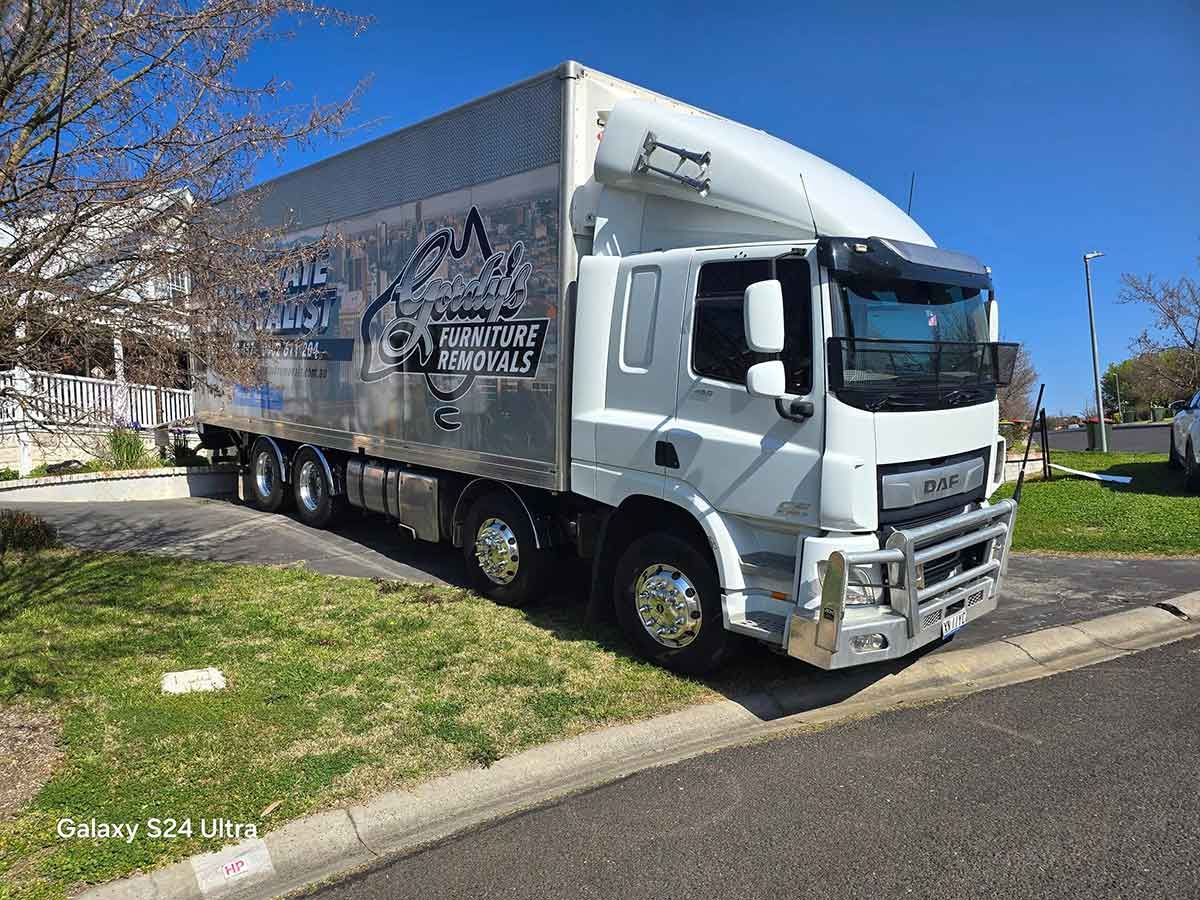 A Large White Truck Is Parked On The Side Of The Road — Gordy's Furniture Removals in Bathurst, NSW