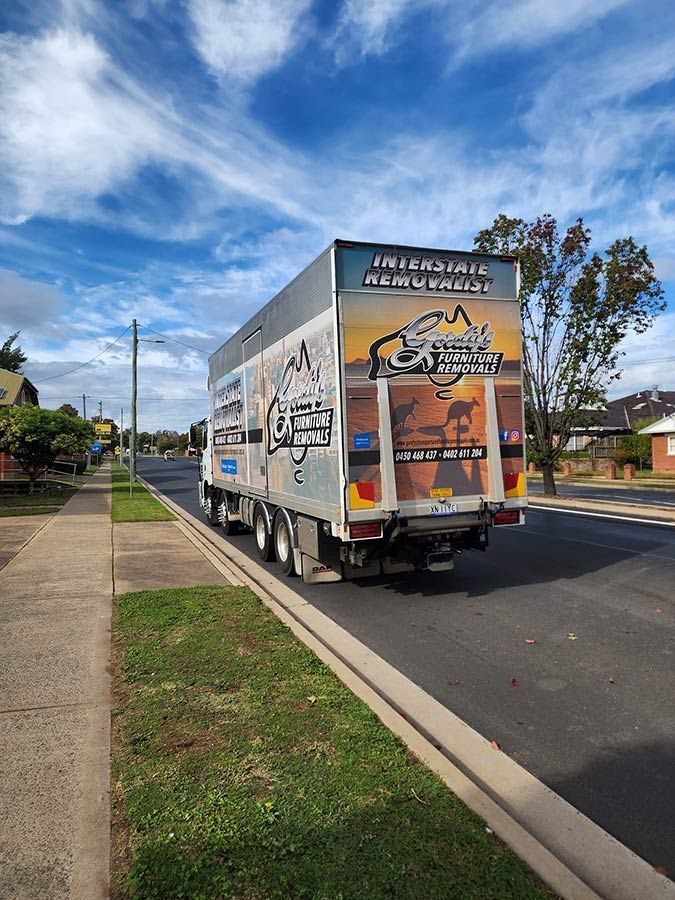 A Large Moving Truck Is Parked On The Side Of The Road — Gordy's Furniture Removals in Bathurst, NSW