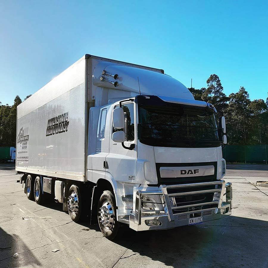 A White Daf Truck Is Parked In A Parking Lot — Gordy's Furniture Removals in Bathurst, NSW