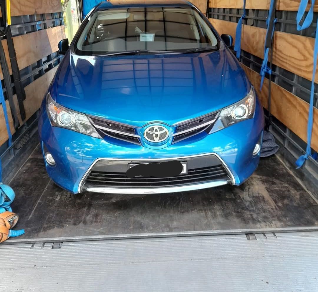 A Blue Toyota Car Is Parked In The Back Of A Truck — Gordy's Furniture Removals in Bathurst, NSW