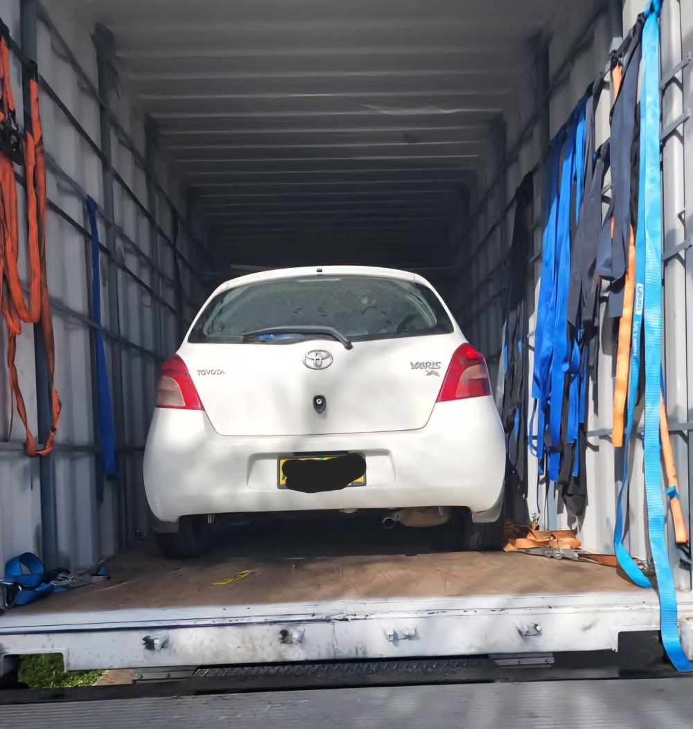 A White Car Is Parked In The Back Of A Truck — Gordy's Furniture Removals in Cowra, NSW