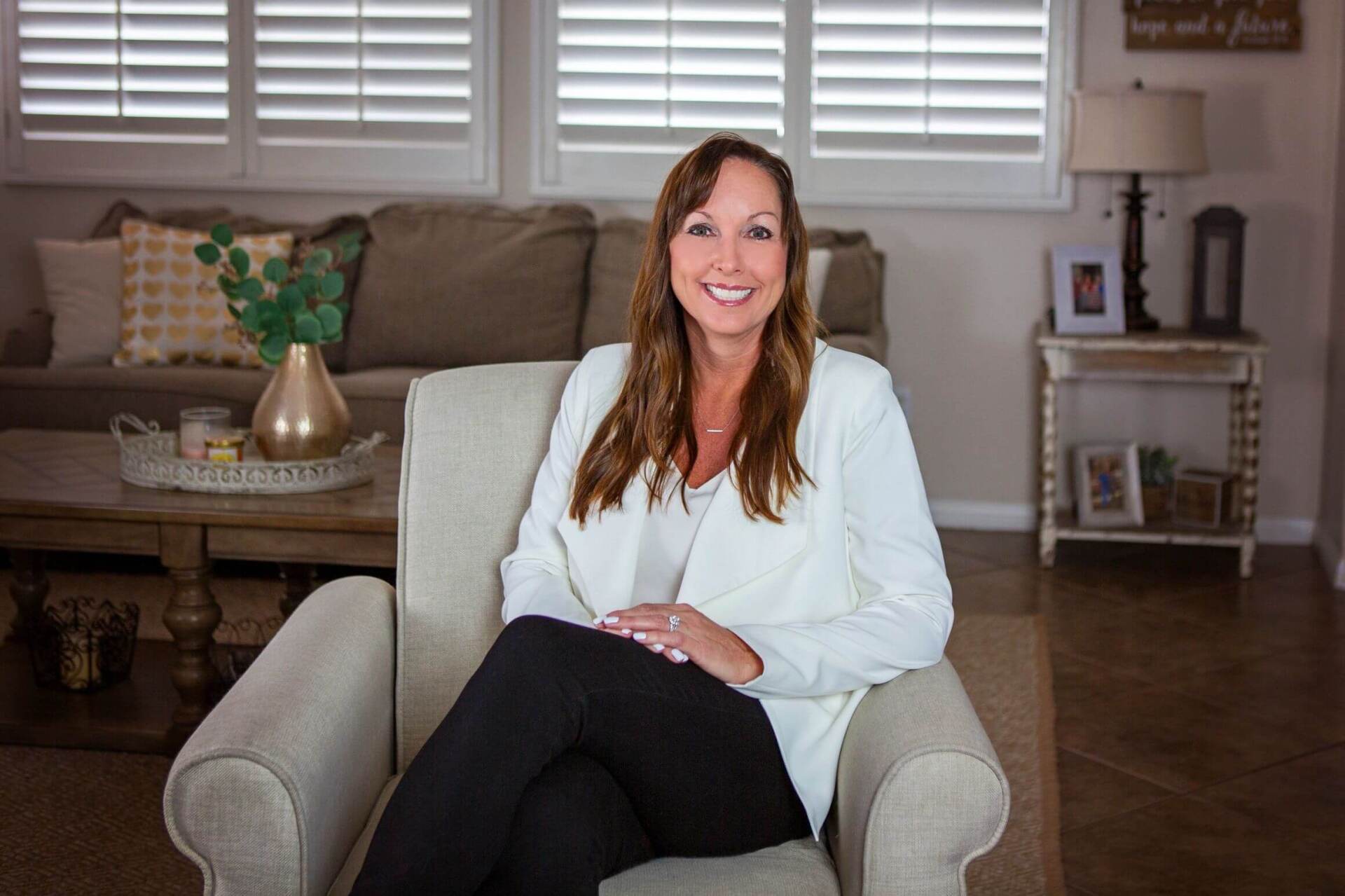 Leah Amico sitting in a chair with a white blazer Leah Amico sitting in a chair with a white blazer