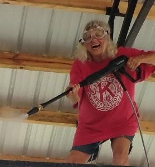 Happy woman holding a pressure washing