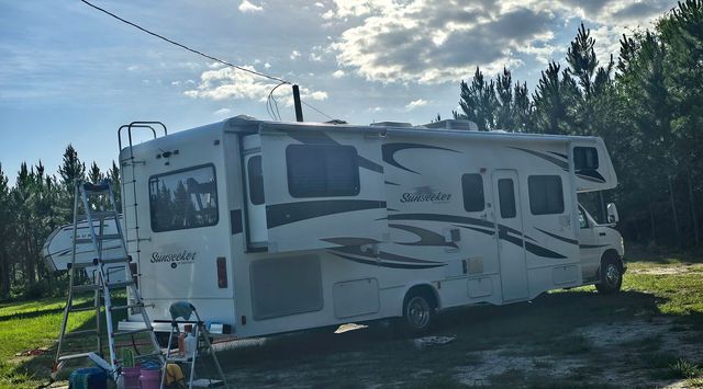White RV motorhome parked on the street