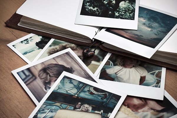 a bunch of pictures are laying on top of a book