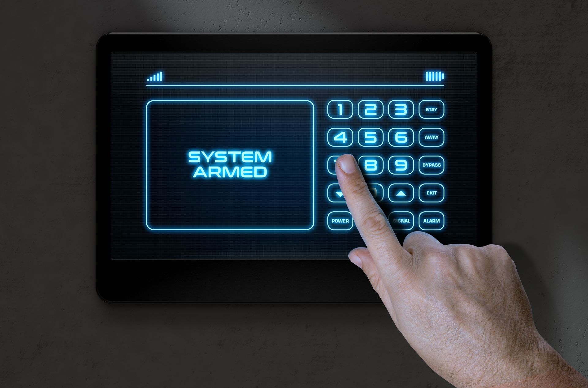 Hand pressing a lit security keypad displaying “SYSTEM ARMED” on a dark alarm panel