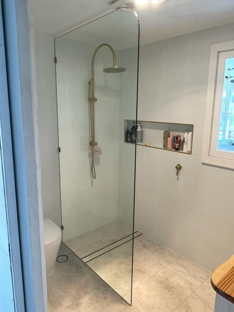 A Modern Bathroom with A Glass Shower Enclosure — Envy Glass in Coffs Harbour, NSW
