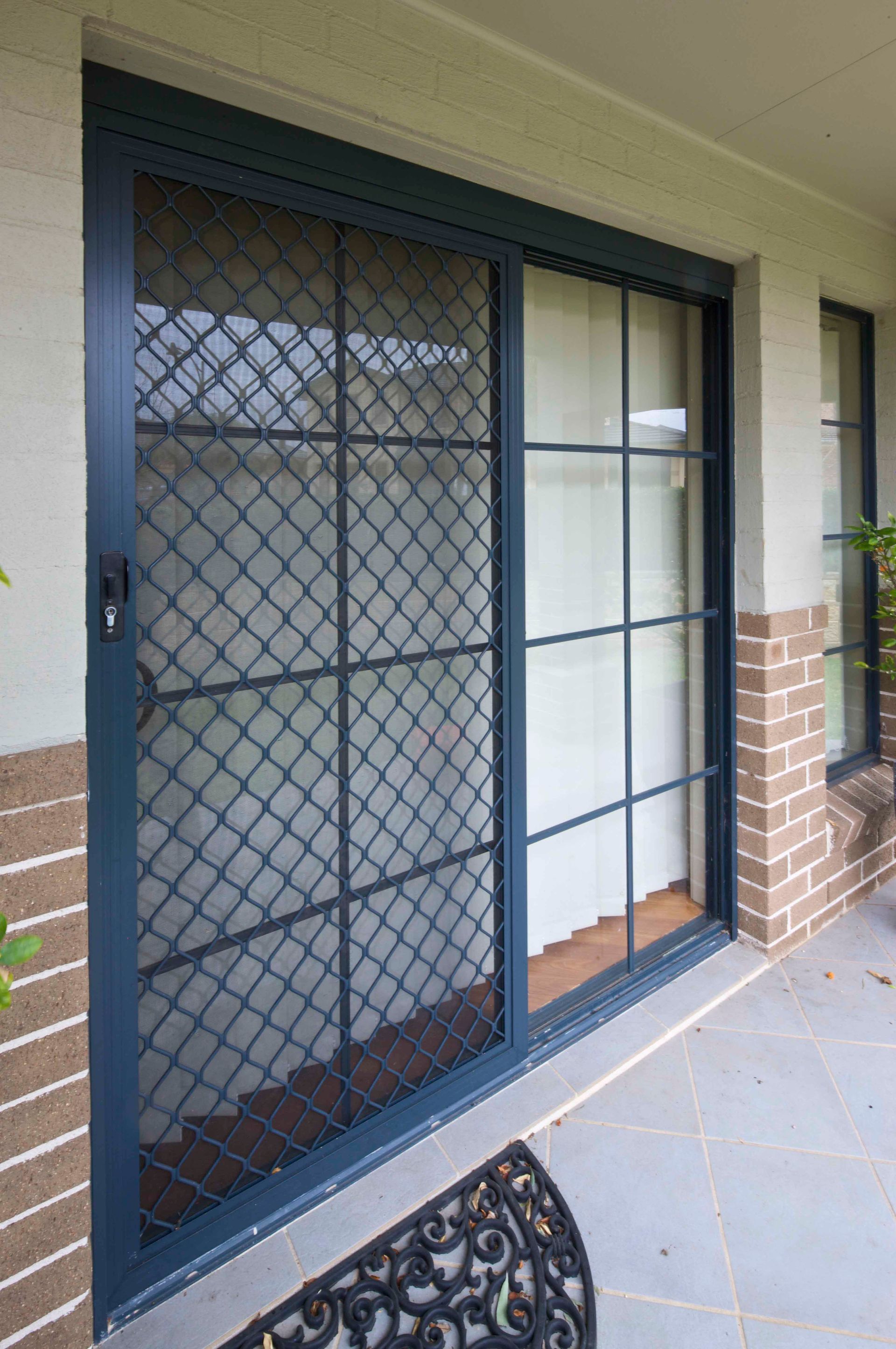 Blue Framed Sliding Glass Door With Diamond Security Screen — Envy Glass in Nambucca Heads, NSW