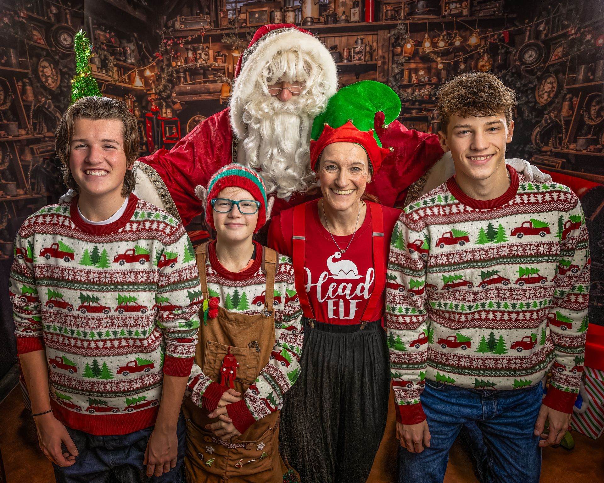 Santa Claus with excited children, laughing, in a festive setting, with a Christmas tree and stockings.