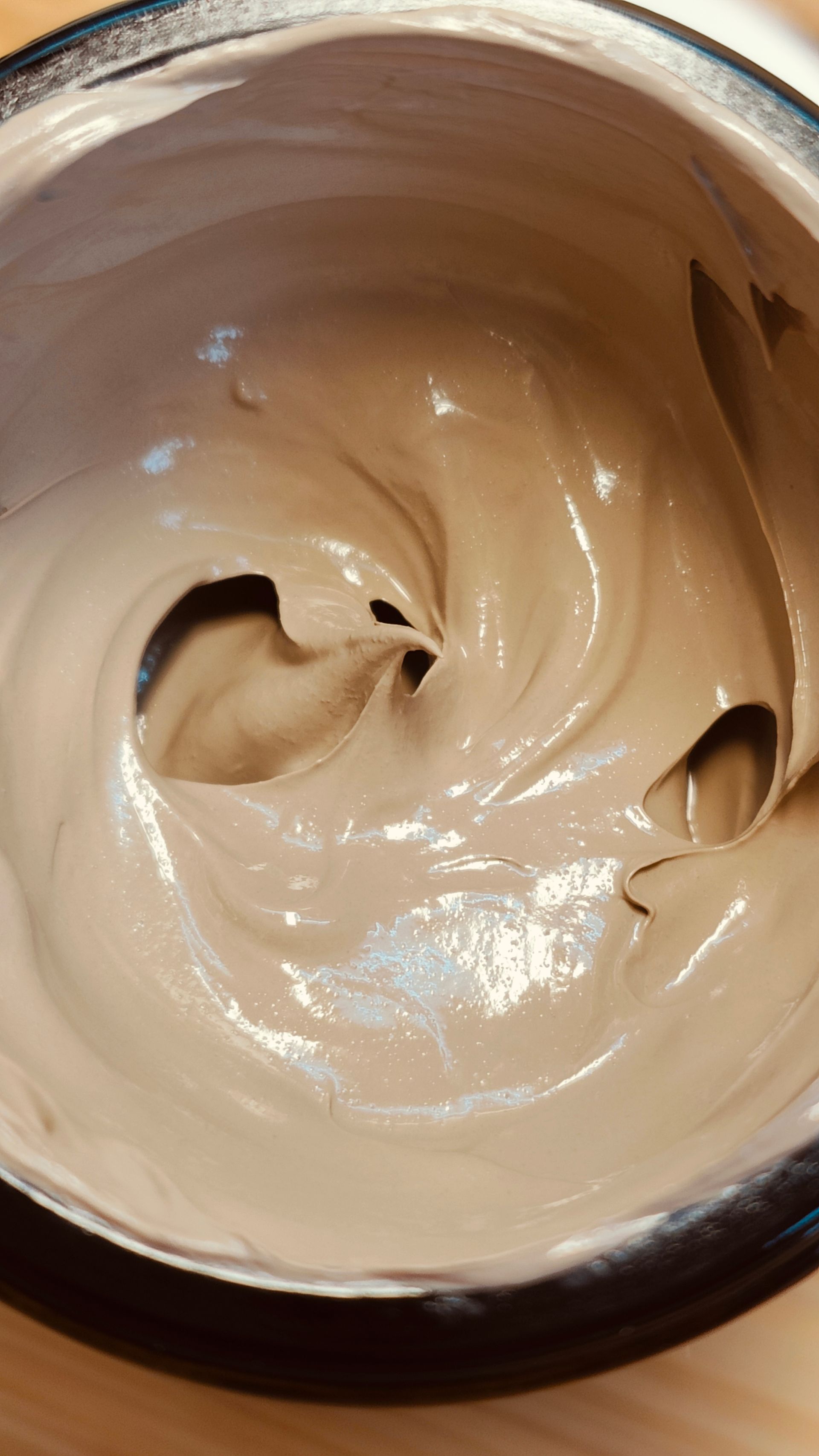 Dark jar of Au Elemental tinted SPF 30 broad spectrum sunscreen with white label and lid.