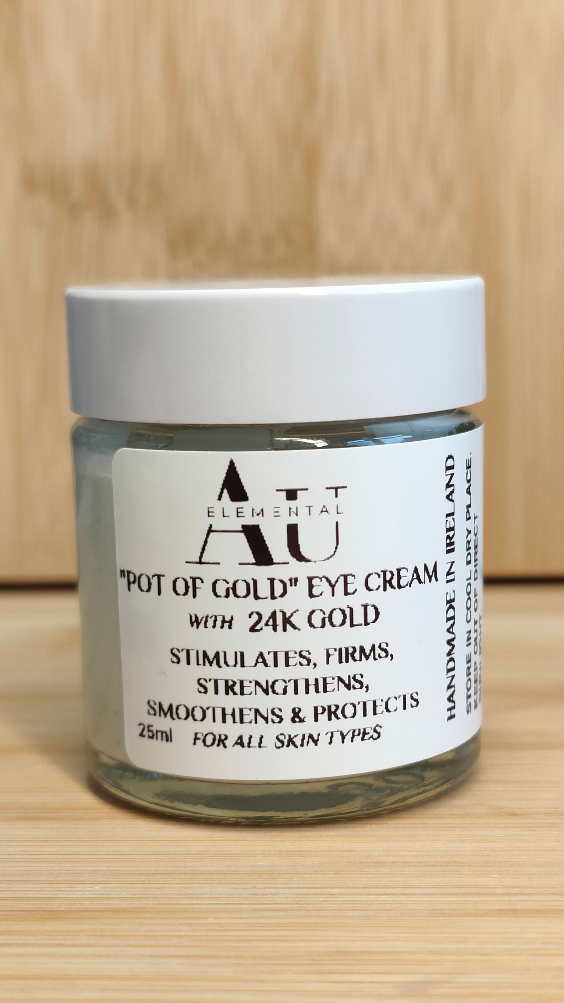 Small glass jar of eye cream with a white label, the label has text that reads