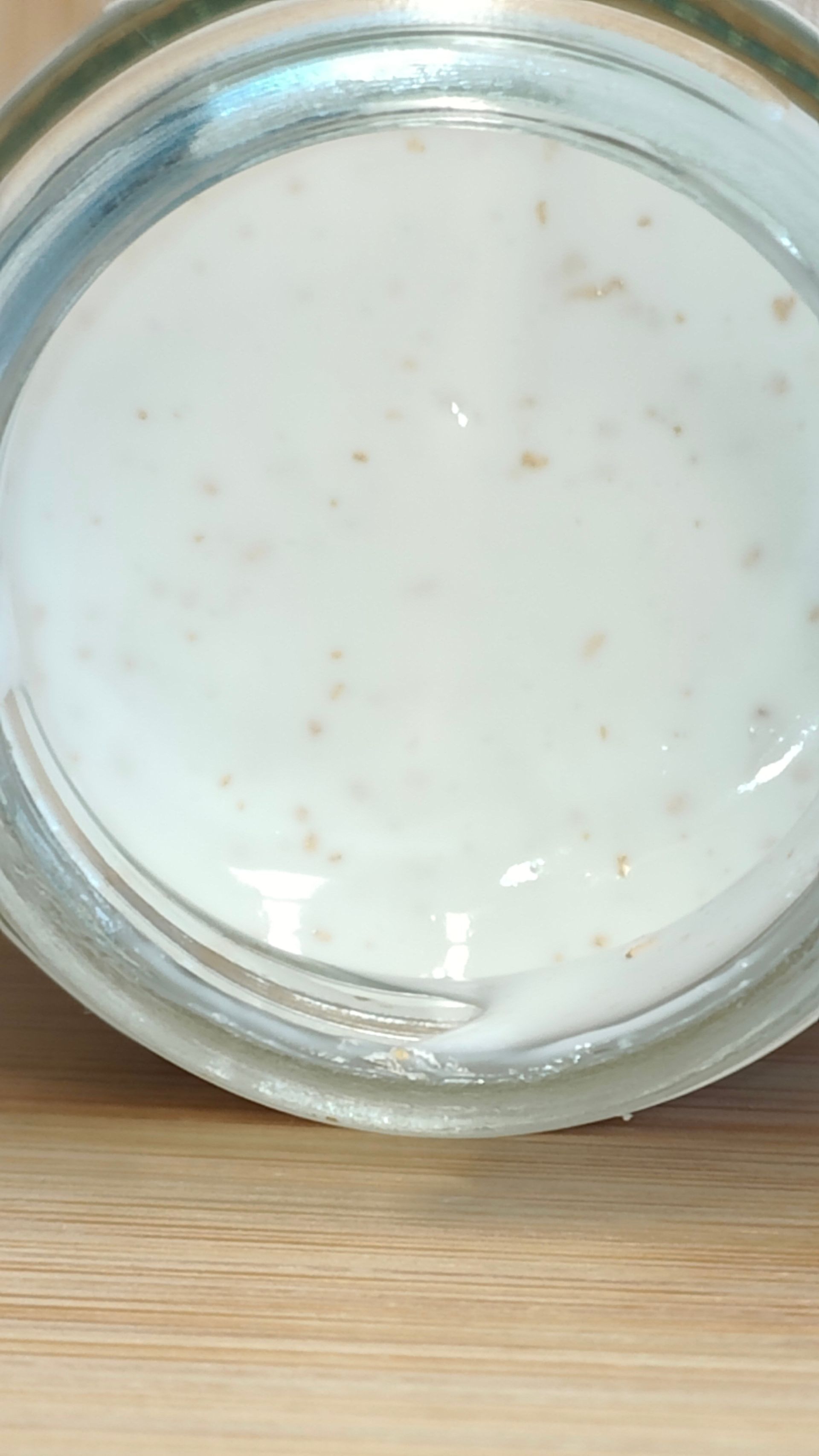 Small glass jar of eye cream with a white label, the label has text that reads