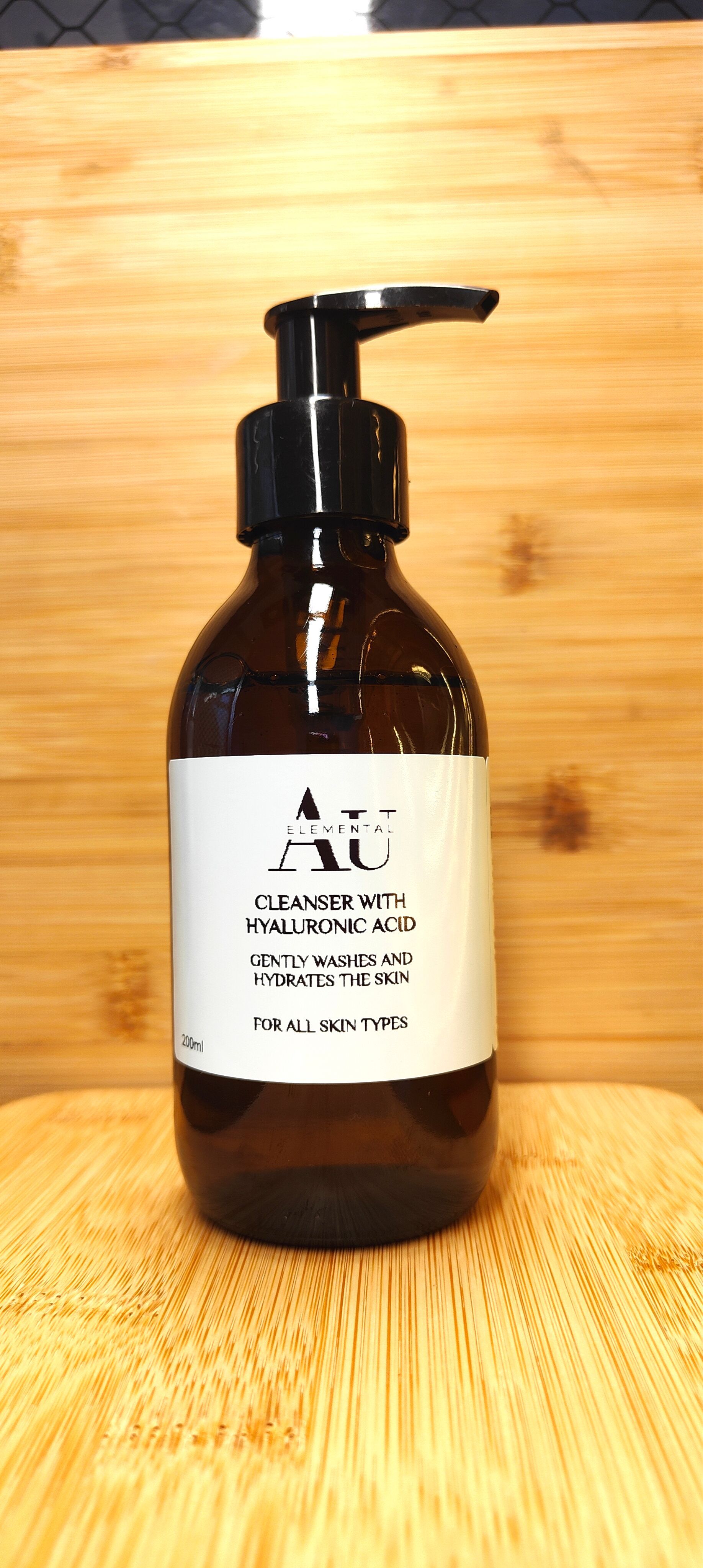 A brown pump bottle with a white label on a wooden surface.