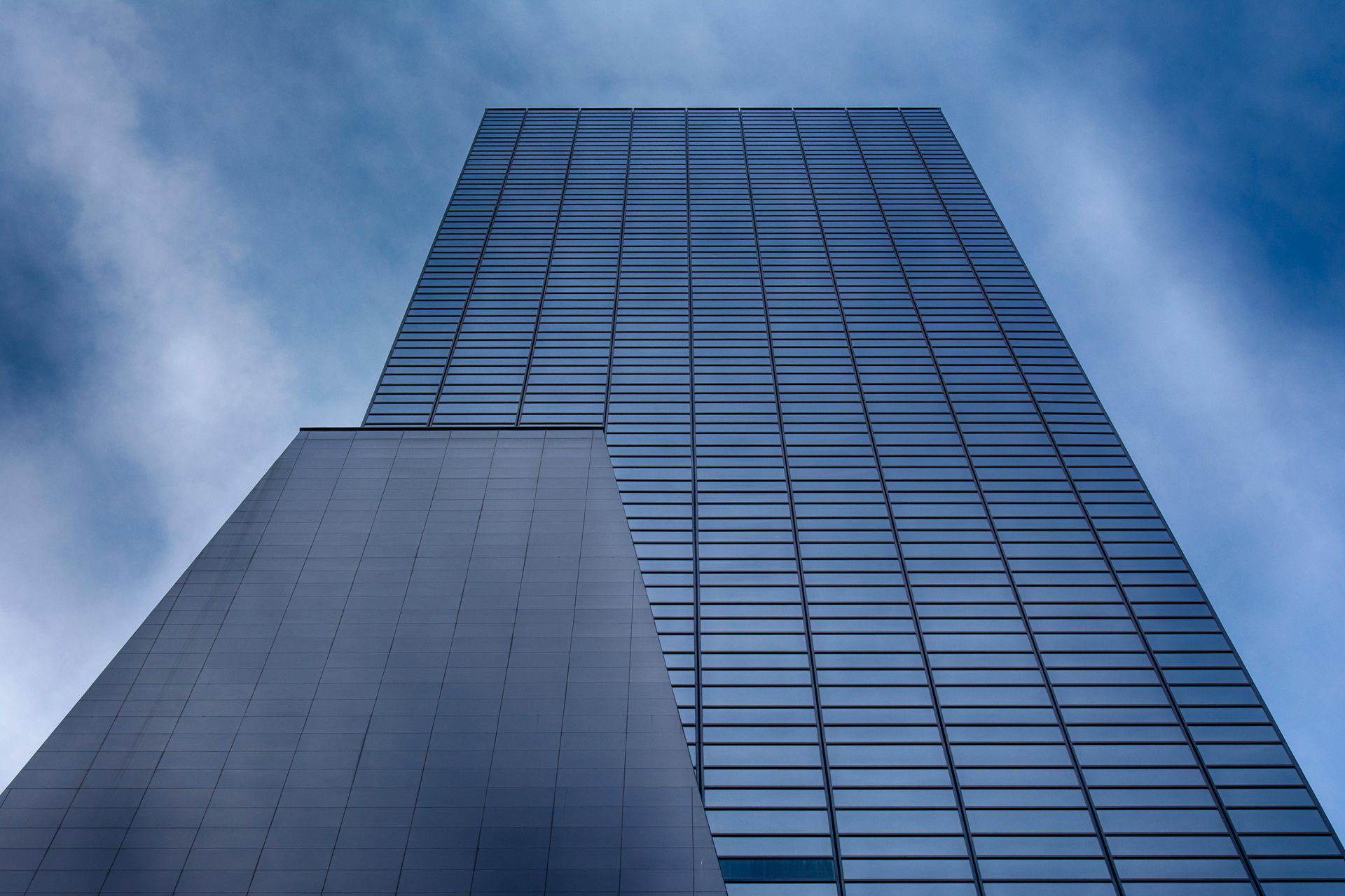 Mirando hacia un edificio alto con un cielo azul de fondo