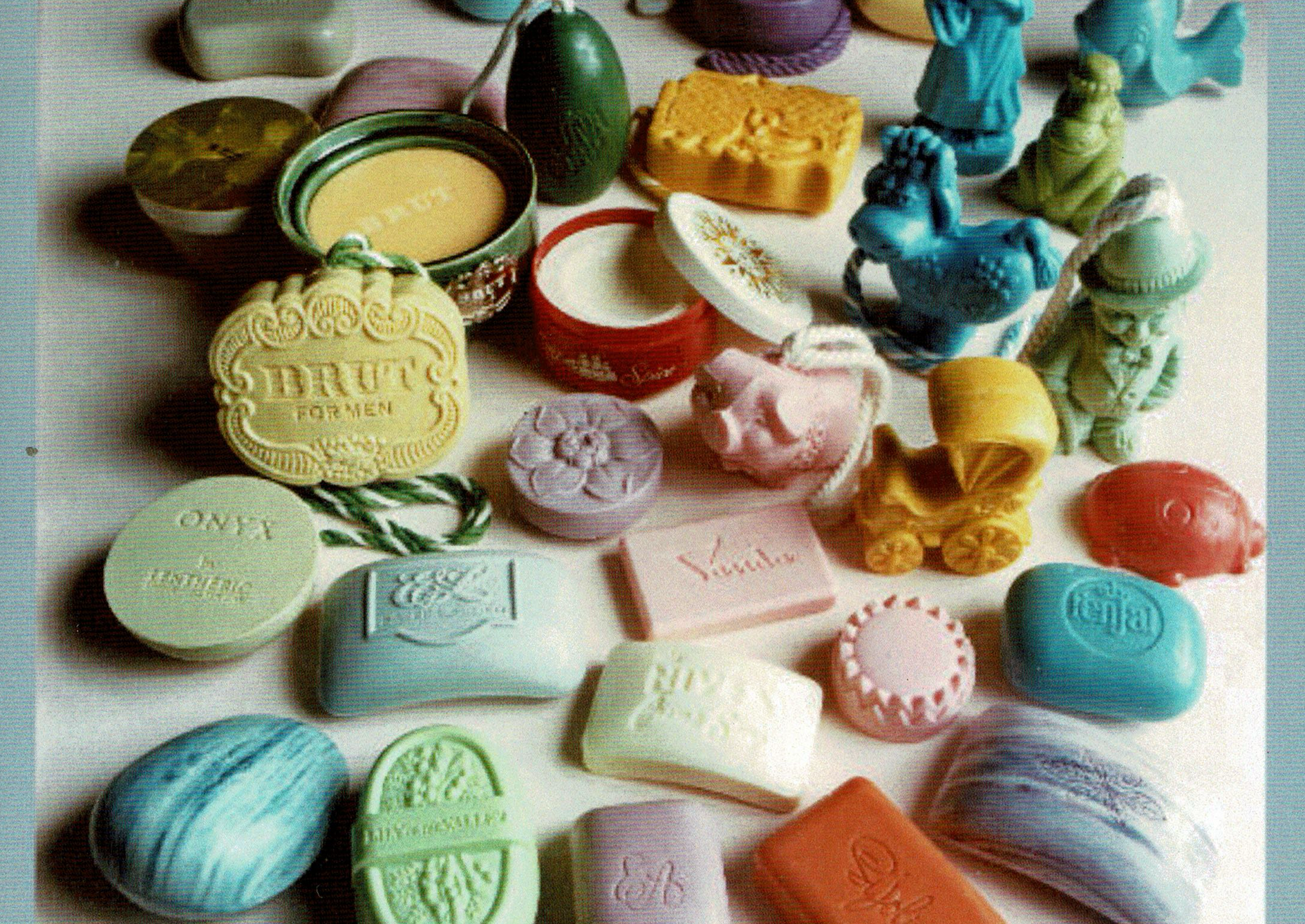 Variety of colorful decorative soaps in different shapes, including a train, horse, and round containers.