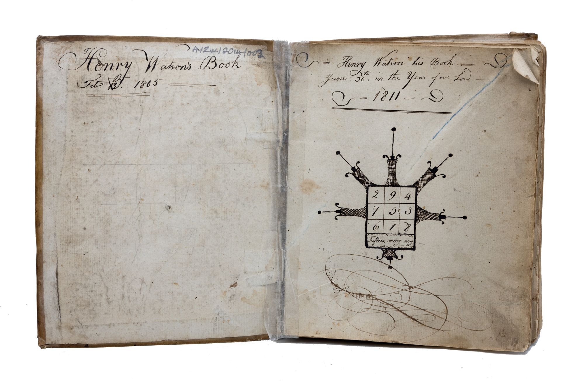 Open book with handwritten text and a diagram of an object