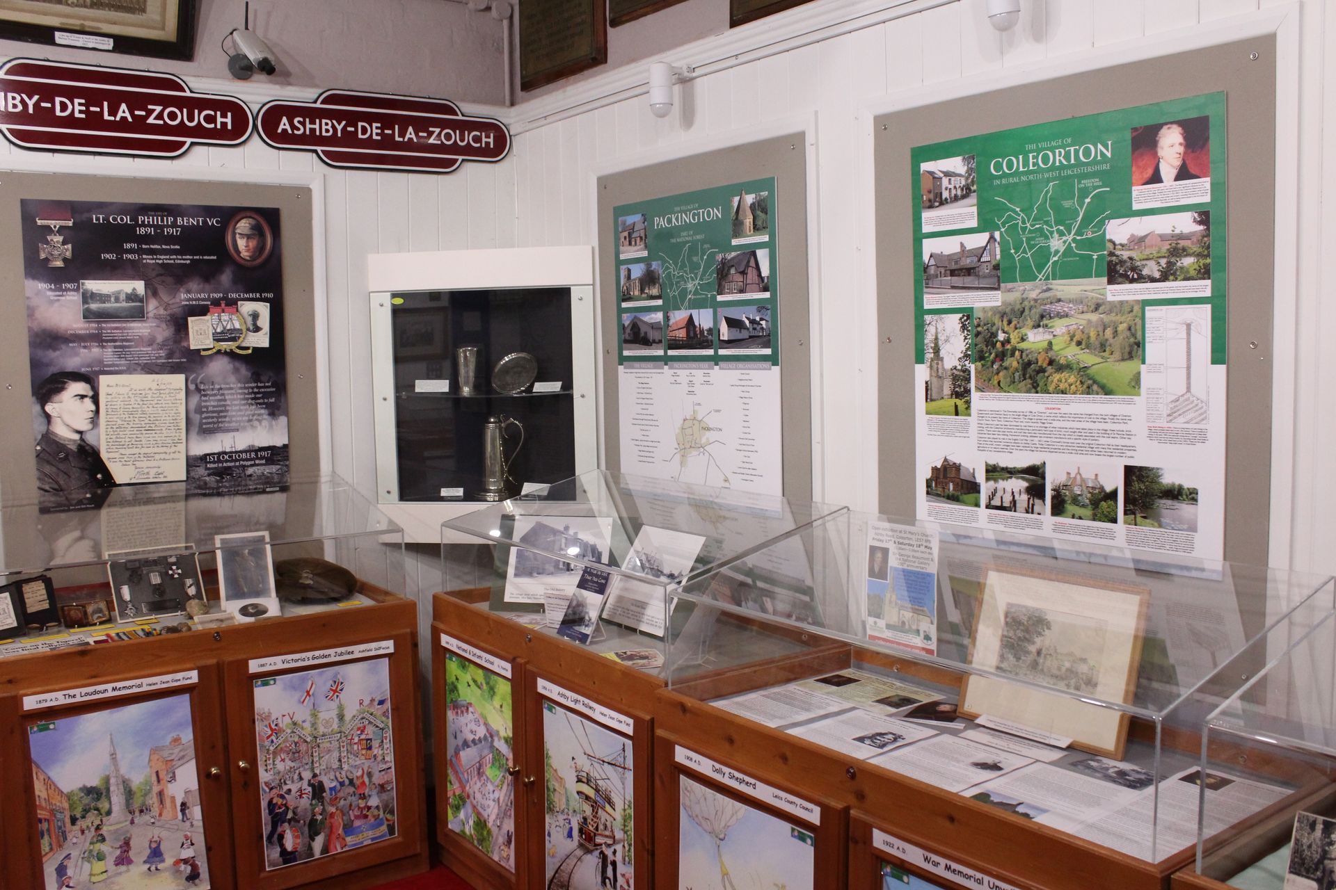 A room with a red carpet and wooden cabinets with pictures on them