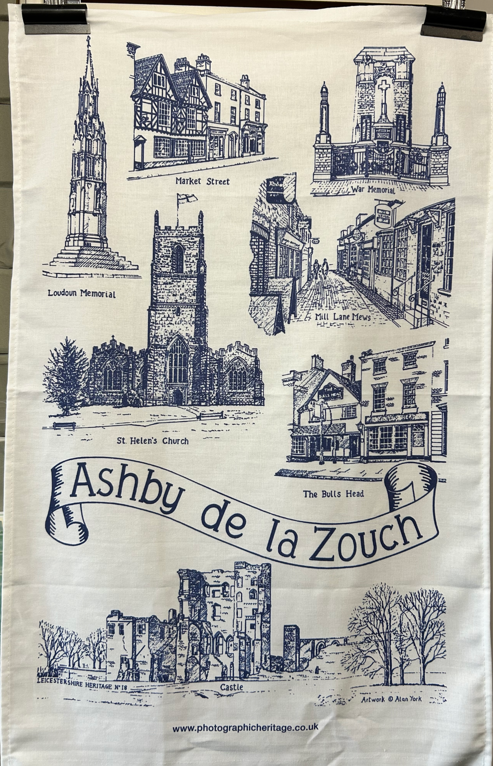 Blue and white tea towel with illustrations of Ashby de la Zouch buildings and the town name.