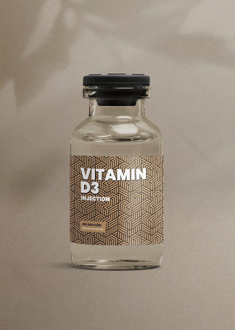 Small clear bottle labeled “Vitamin D3” with a black cap on a beige surface.