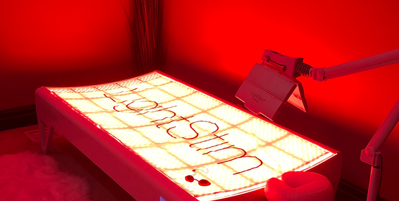 A bed with a red light on it and a sign on it.