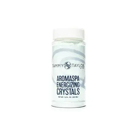 A bottle of aromaspa energizing crystals on a white background.