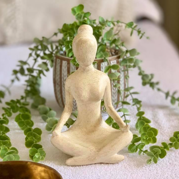 meditation statue and a plant
