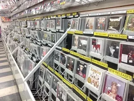 A shelf filled with lots of cds in a store.