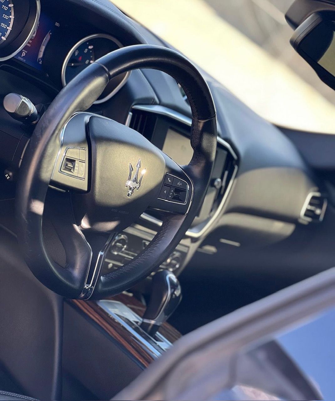 A close up of the steering wheel of a car