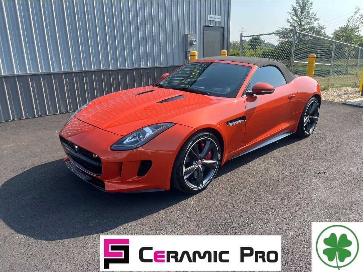 A red sports car is parked in front of a building.