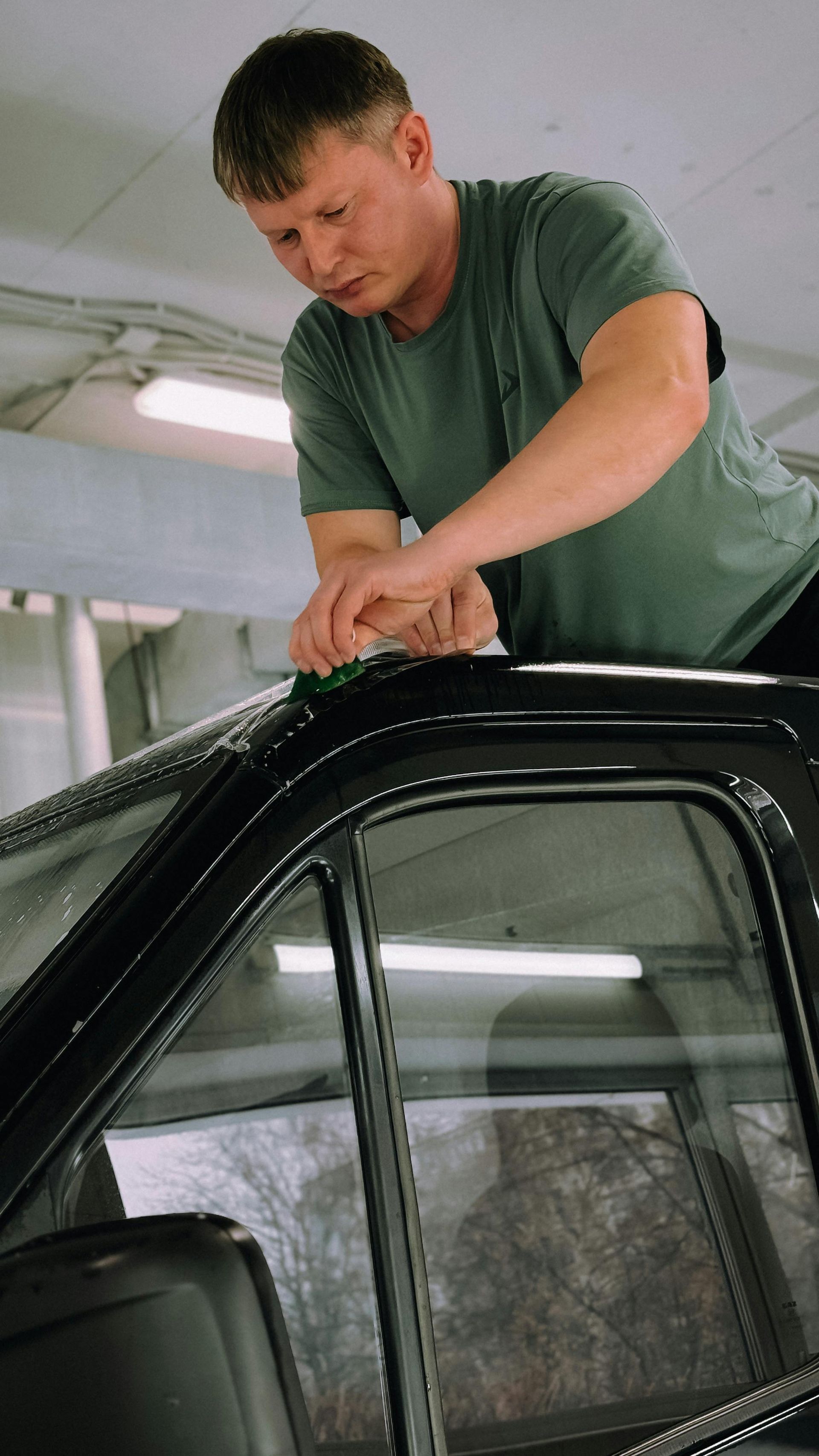 Black pickup truck parked indoors on a wet floor in a garage or wash bay