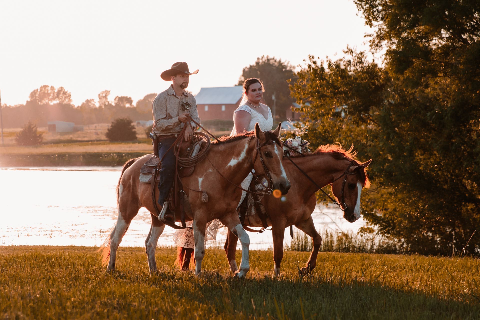 A man and a woman are riding horses in a field.