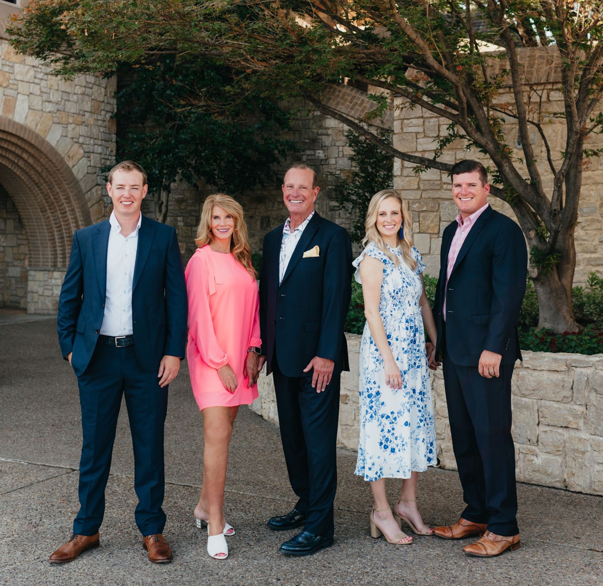 A group of people standing next to each other in front of a building
