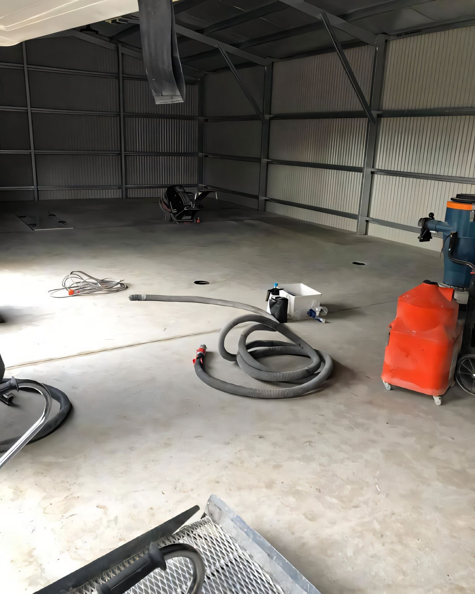 There is a vacuum cleaner in the middle of the room. — Partlic Painting & Epoxy Flooring In Taree, NSW