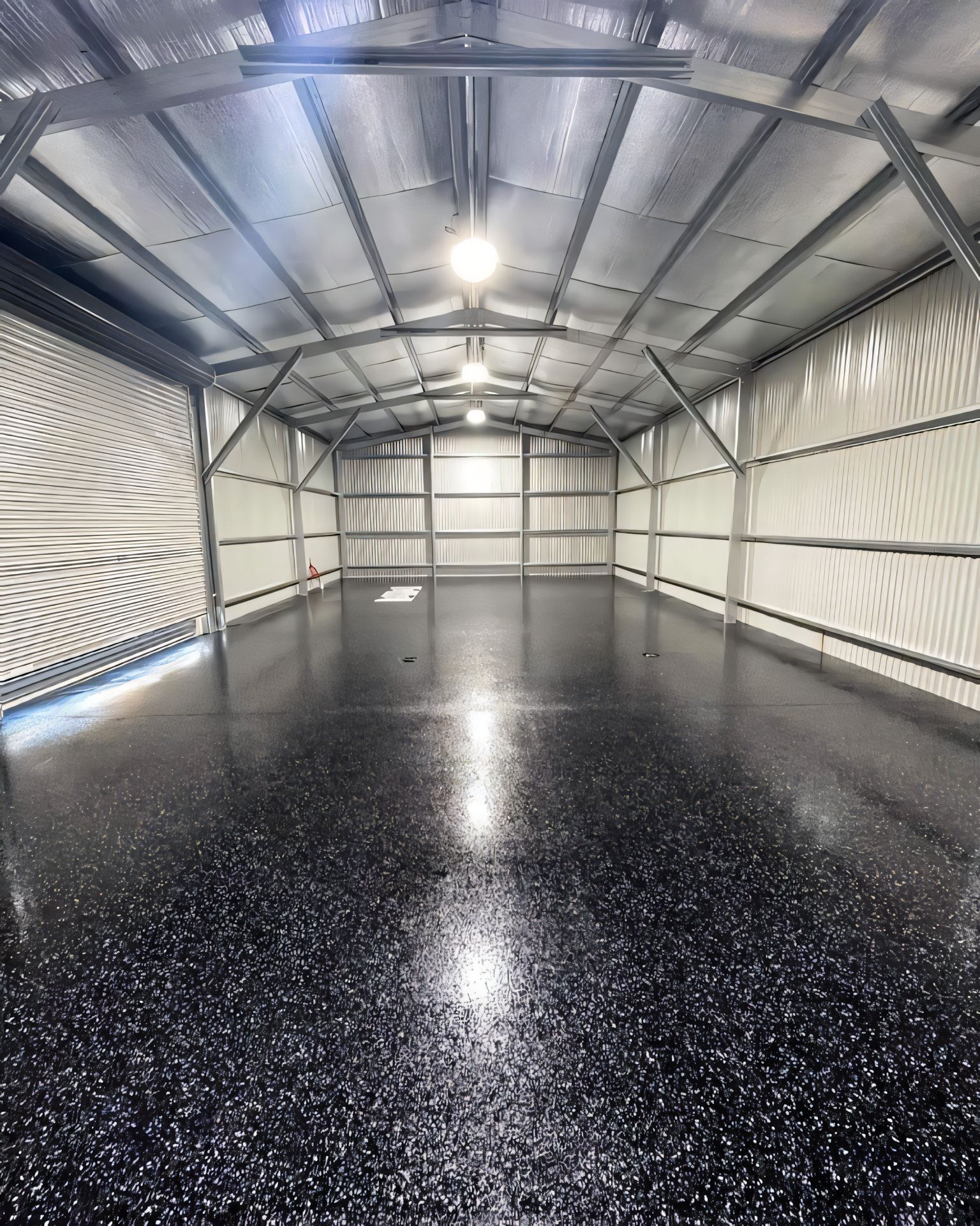 A large empty garage with a black floor and white walls. — Partlic Painting & Epoxy Flooring In Taree, NSW