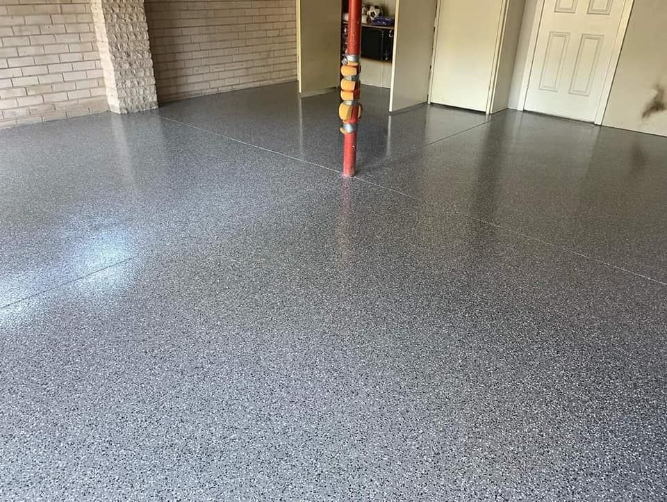 A Garage With A Concrete Floor And A Brick Wall — Partlic Painting & Epoxy Flooring In Taree, NSW