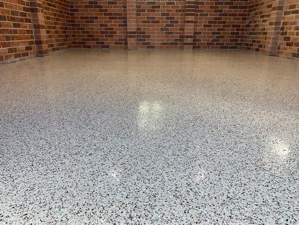 A Garage With A Brick Wall And A White Floor — Partlic Painting & Epoxy Flooring In Taree, NSW