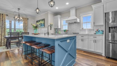 A kitchen with a large island in the middle of it.