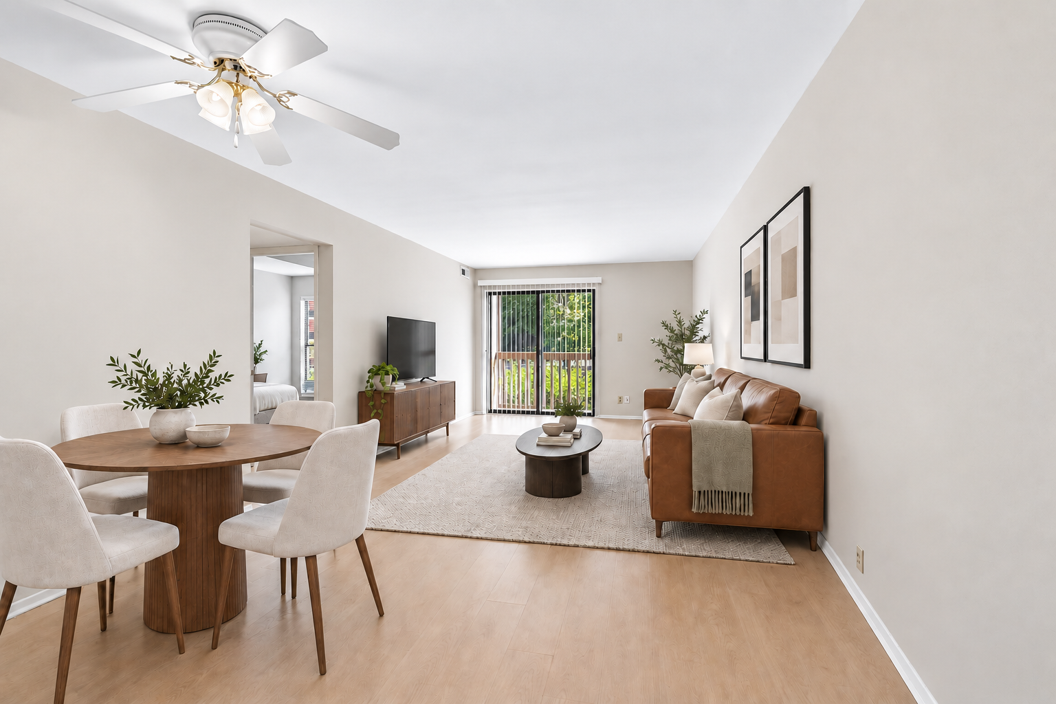 Staged living and dining area with balcony access at Village Park Apartments