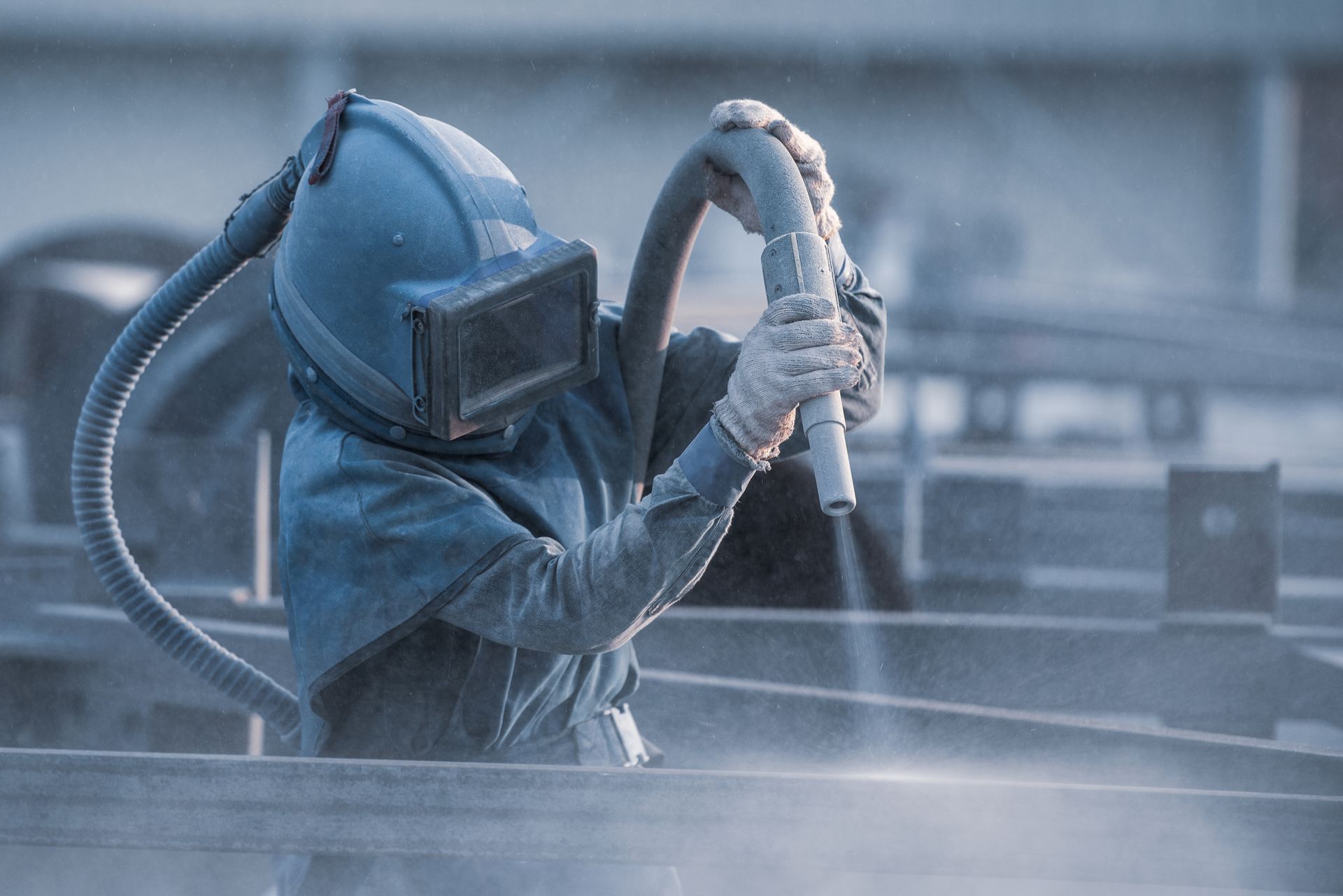 Sand blasting process, Industial worker using sand blasting process preparation cleaning surface on steel before painting in factory workshop. Sand blasting process, Industial worker using sand blasting process preparation cleaning surface on steel before painting in factory workshop.
