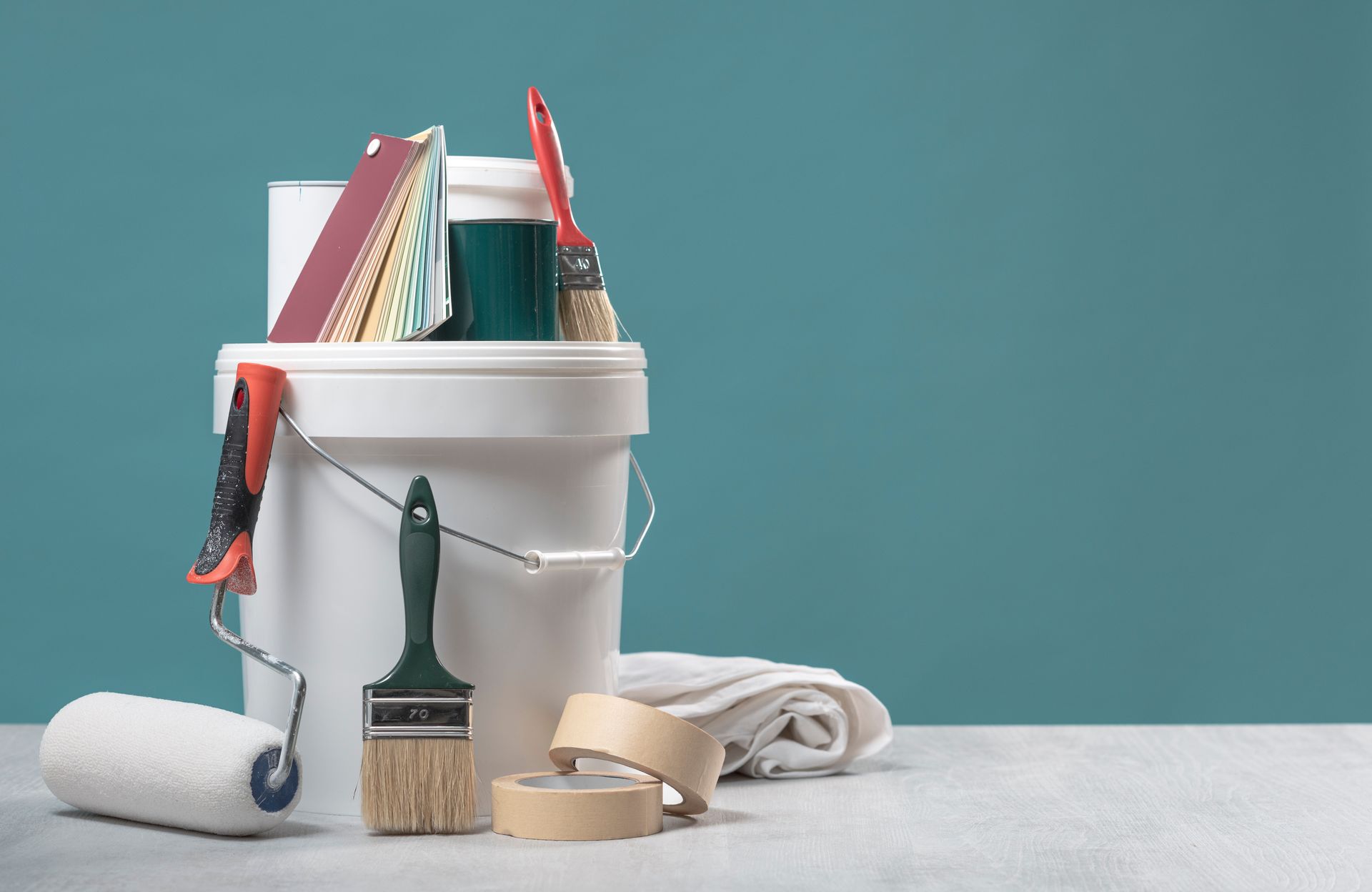 Commercial paint equipment including rollers, brushes, paint buckets, and masking supplies. Commercial paint equipment including rollers, brushes, paint buckets, and masking supplies.
