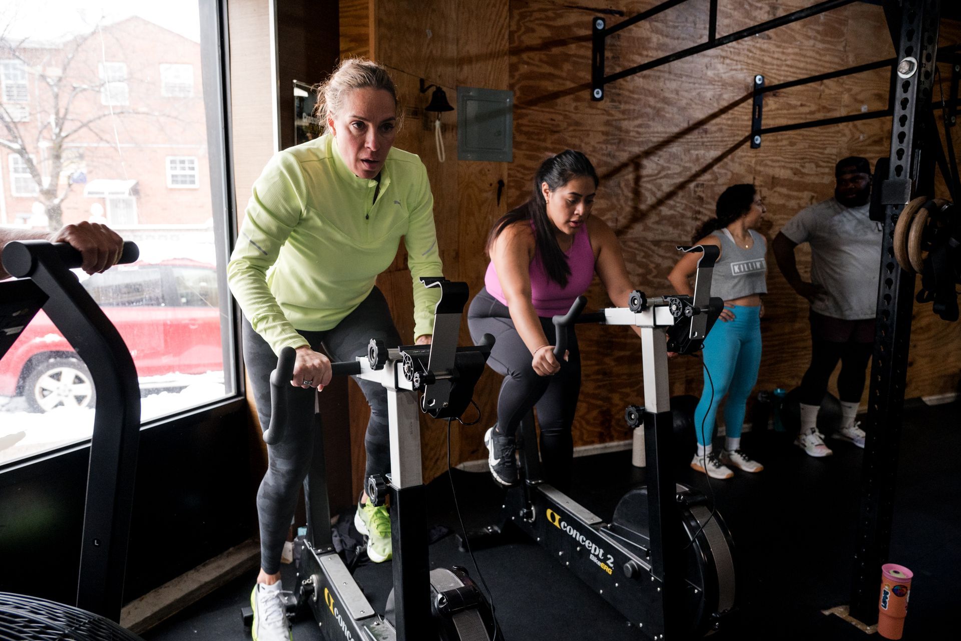 A group of people are riding exercise bikes in a gym.